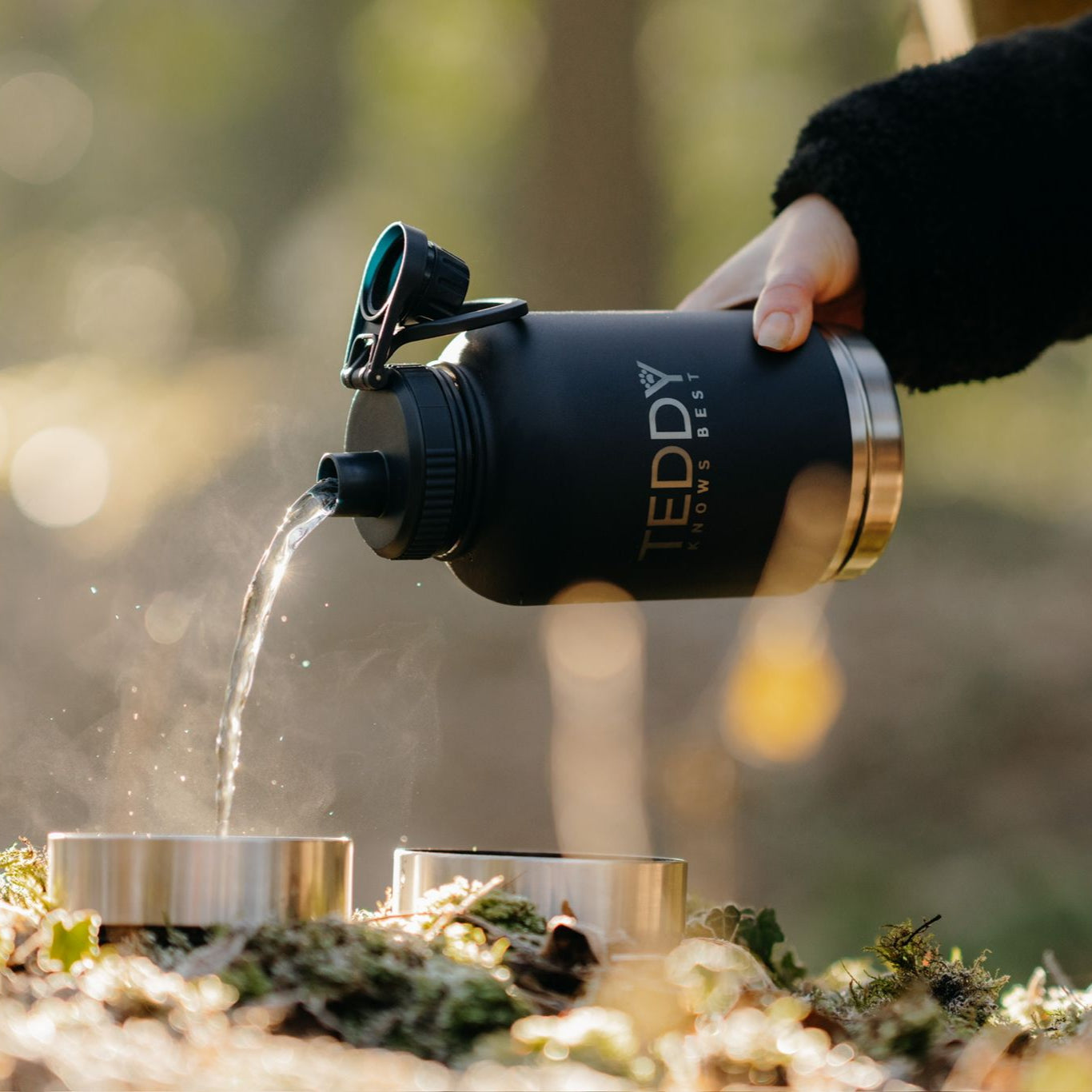 black 3 in 1 portable water bottle for dogs, pouring out water